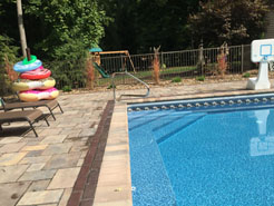 Newly installed pool with custom brick patio.